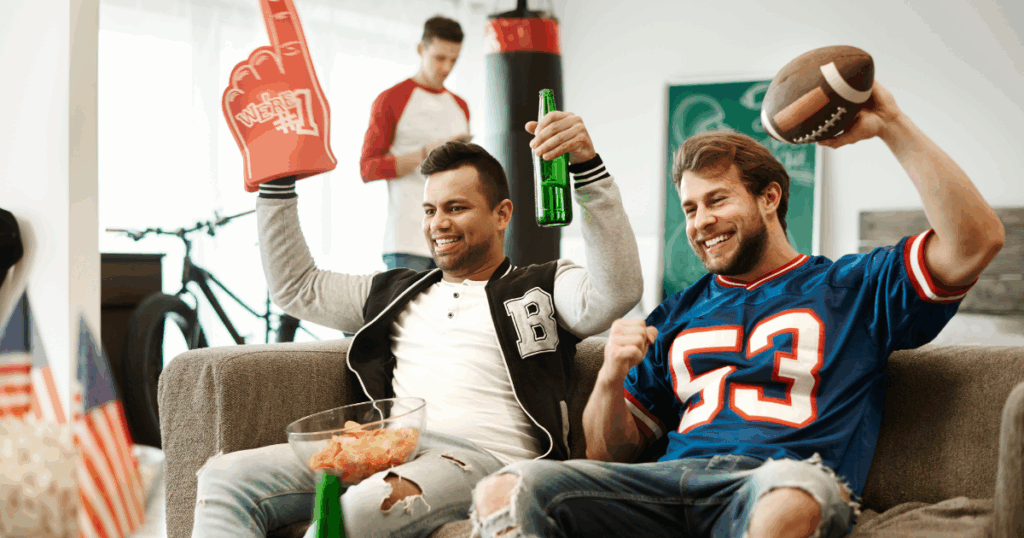 Friends celebrating the perfect game day with beer and snacks in Kansas City