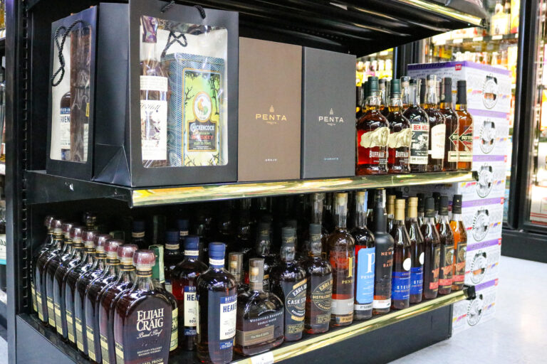 Premium bourbon and tequila bottles on display at Pina Wine & Spirits liquor store in Kansas City