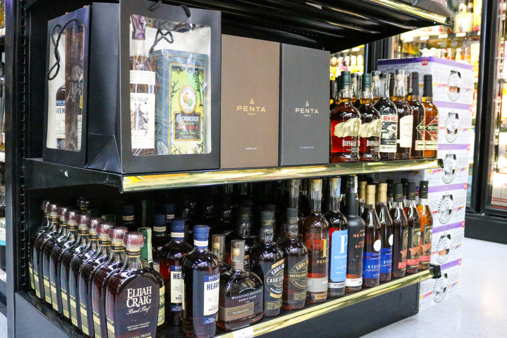 Shelf display of allocated bourbon and premium whiskey at Pina Wine and Spirits in Kansas City during the holiday season.