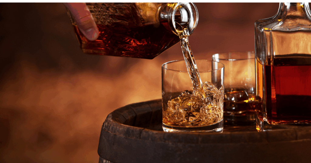 Bourbon being poured over ice from a decanter, representing holiday whiskey and allocated bourbon selections in Kansas City.