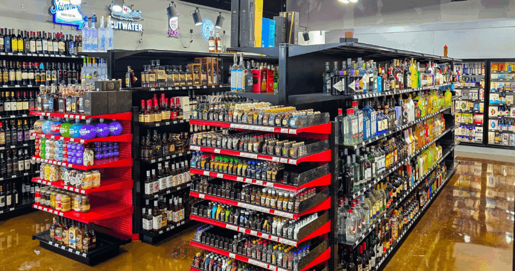 Interior of the new Pina Wine and Spirits store in Lee’s Summit featuring organized shelves stocked with wine, craft beer, whiskey minis, spirits, CBD products, and vape items at Rain Tree Shopping Center.