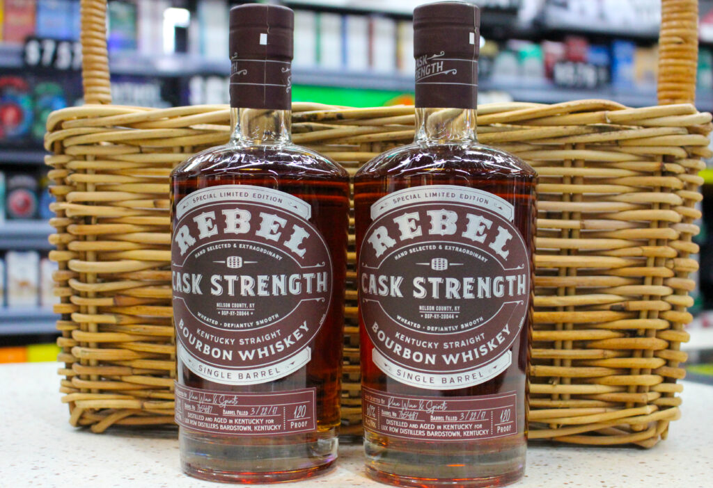 Rebel Cask Strength bourbon bottles displayed at Pina Wine and Spirits, featuring rare and allocated whiskey available in Kansas City.