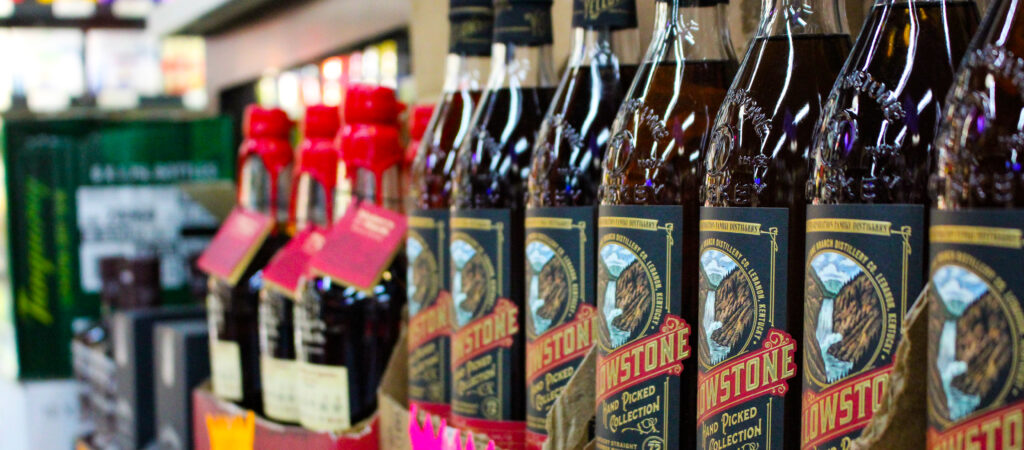 Display of Yellowstone bourbon bottles at Pina Wine and Spirits in Kansas City, popular among holiday hosts and whiskey lovers.