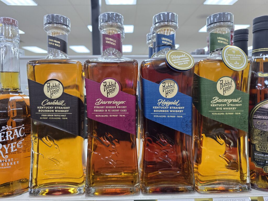 Rabbit Hole bourbon and rye bottles on display at Pina Wine and Spirits, featuring Cavehill, Dareringer, Heigold, and Boxergrail for Kansas City best liquor deals for shoppers.