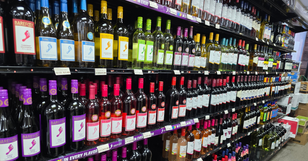 Wine aisle at a Missouri liquor store featuring affordable fine wines including Cabernet Sauvignon, Chardonnay, Pinot Noir, and rosé at Pina Wine and Spirits.