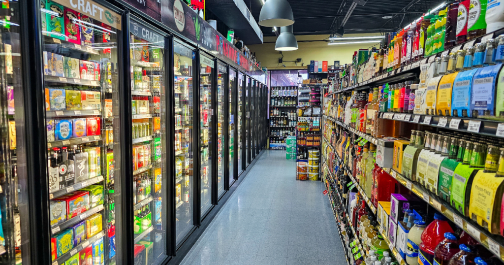 Seasonal Specials at Pina Wine & Spirits: Limited Time Drinks and Community Favorites 1 Liquor store aisle with craft beer coolers, mixers, and seasonal drink selections at Pina Wine & Spirits in Missouri featuring wines, spirits, and limited time beverage specials.