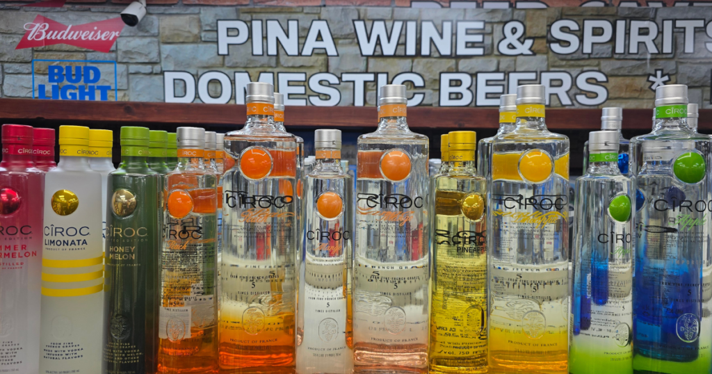 Premium spirits of vodka bottles including Tito’s Handmade Vodka and flavored vodka selections displayed at a Missouri liquor store offering premium spirits at affordable prices.