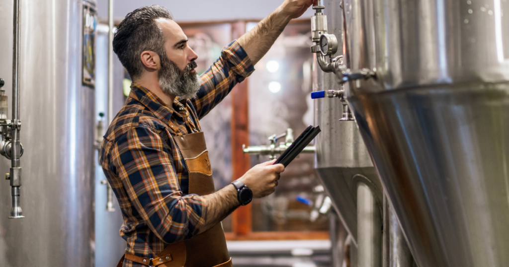Brewer checking tanks in a craft brewery for Missouri craft beer and local beers in Kansas City