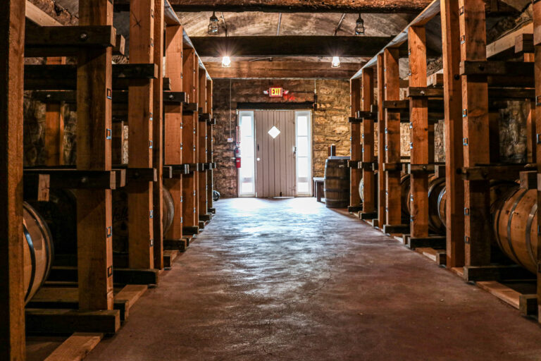 Missouri bourbon barrels aging inside a distillery rickhouse for Kansas City shoppers exploring Missouri-made spirits