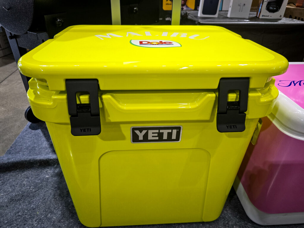 Bright yellow Malibu-branded cooler raffle prize displayed at Pina Wine & Spirits Odessa.