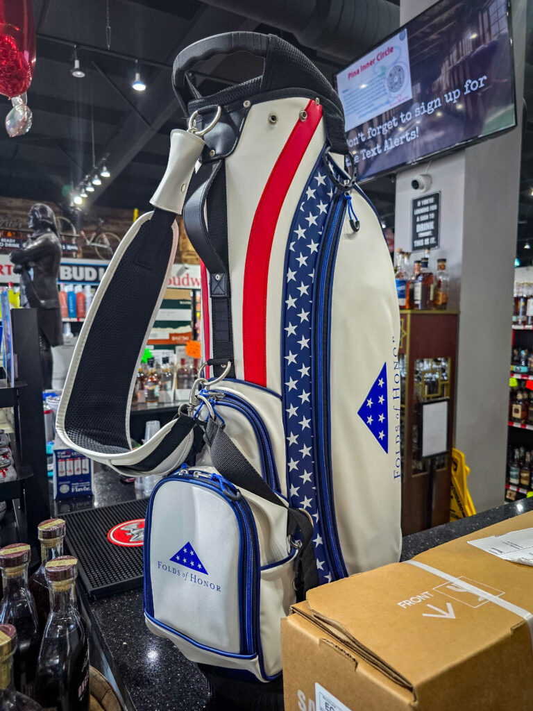 Budweiser Folds of Honor golf bag raffle prize displayed at Pina Wine & Spirits Odessa.